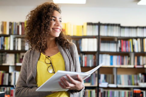 Smiling student in library