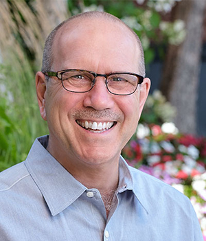 headshot of Mark. R. Warren