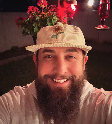 Smiling Arizona teacher Dylan Wince in a cap 