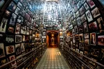 US Holocaust Museum photo of a hallway with floor to ceiling photographs of concentration camp victirms