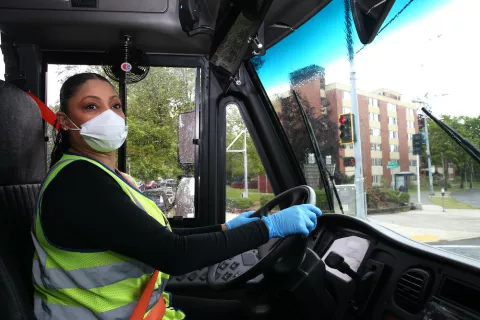 A school bus driver wears a mask