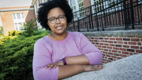 Counselor Shaniqua Williams stands outside her school