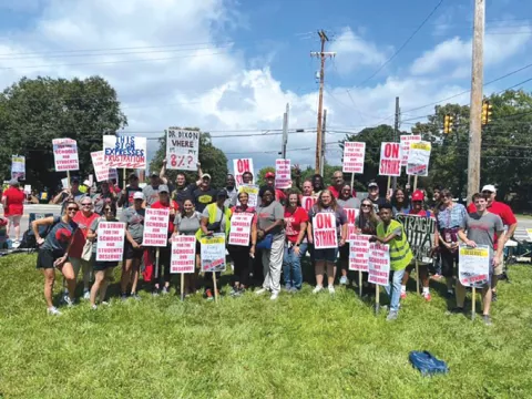 Ohio's Columbus Education Association Educators on strike posing with picket signs.