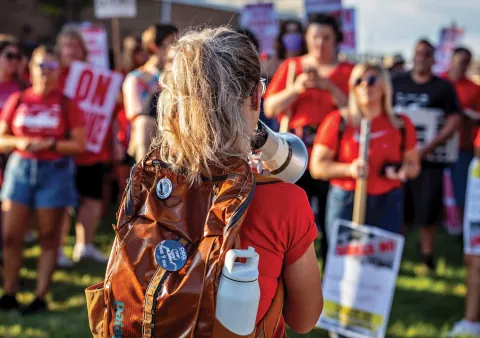 Activist speaking through a bullhorn at a rally.