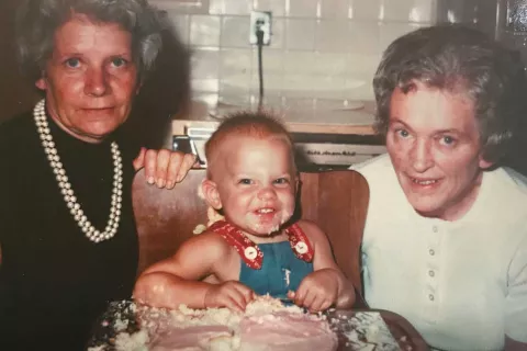 Caucassian grandmother, mother and infant son posing.