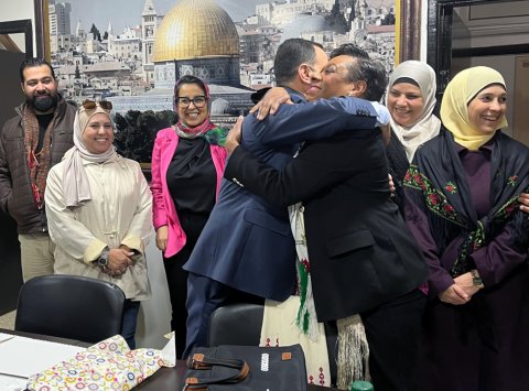 NEA President Becky Pringle meets with and hugs one of the members of the general union of Palestinian teachers.