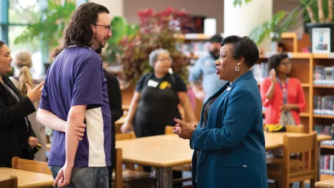 Becky Pringle talks with a Fairfax educator in a school library