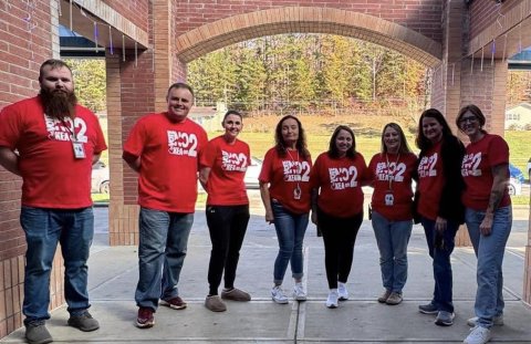 Educators in red campaign T-shirts