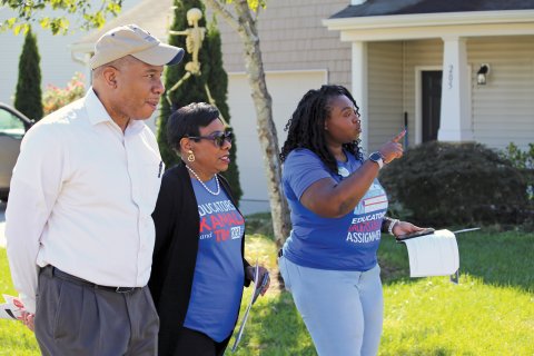 Becky Pringle walks through a neighborhood with NCEA President Tamika Walker Kelly and State Superintendent Mo Green